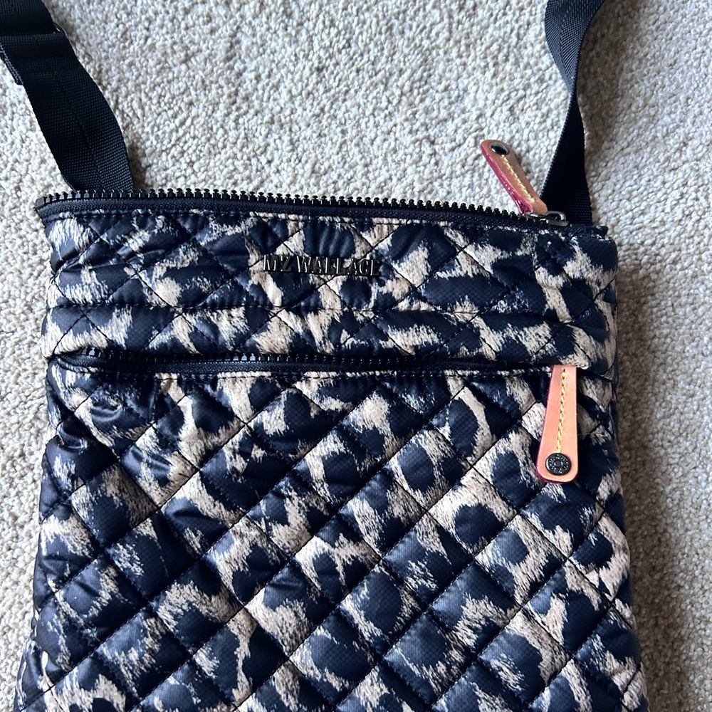 Zip top closure ext front zip pocket, back snap pocket 6 interior pockets